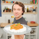 Celenza holding up plate with finished recipe